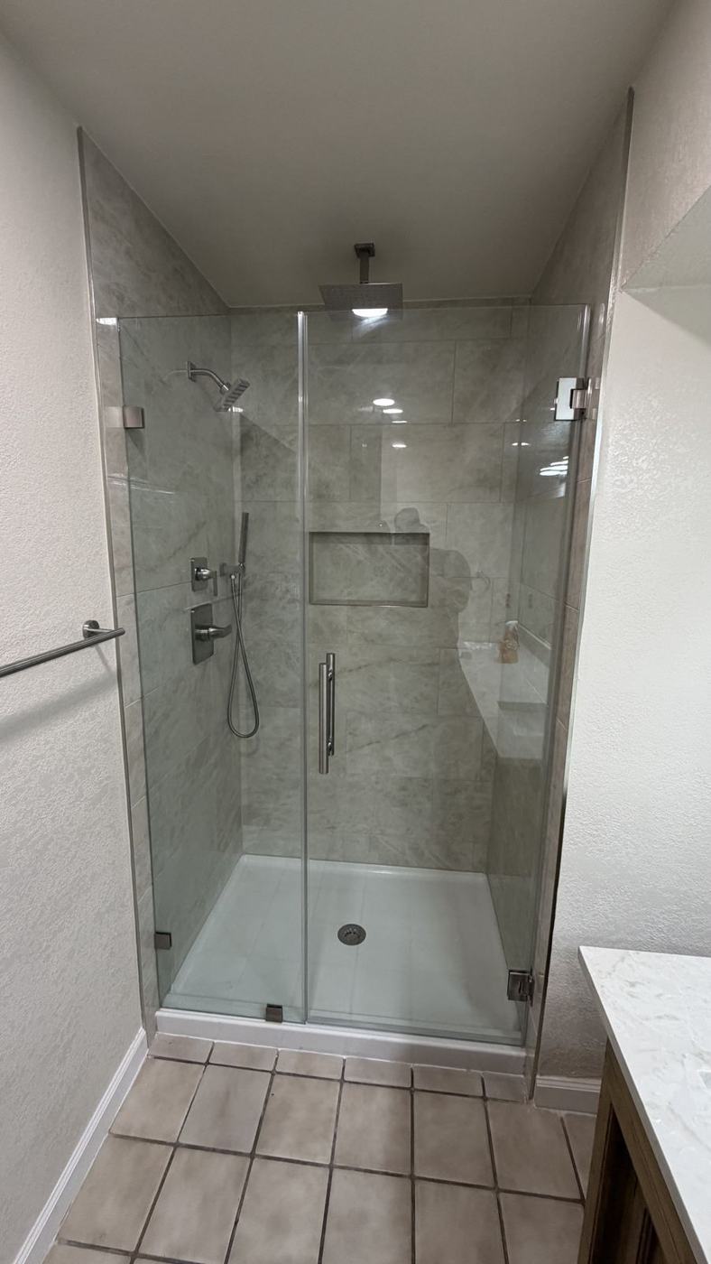 Remodeled walk-in shower with glass door