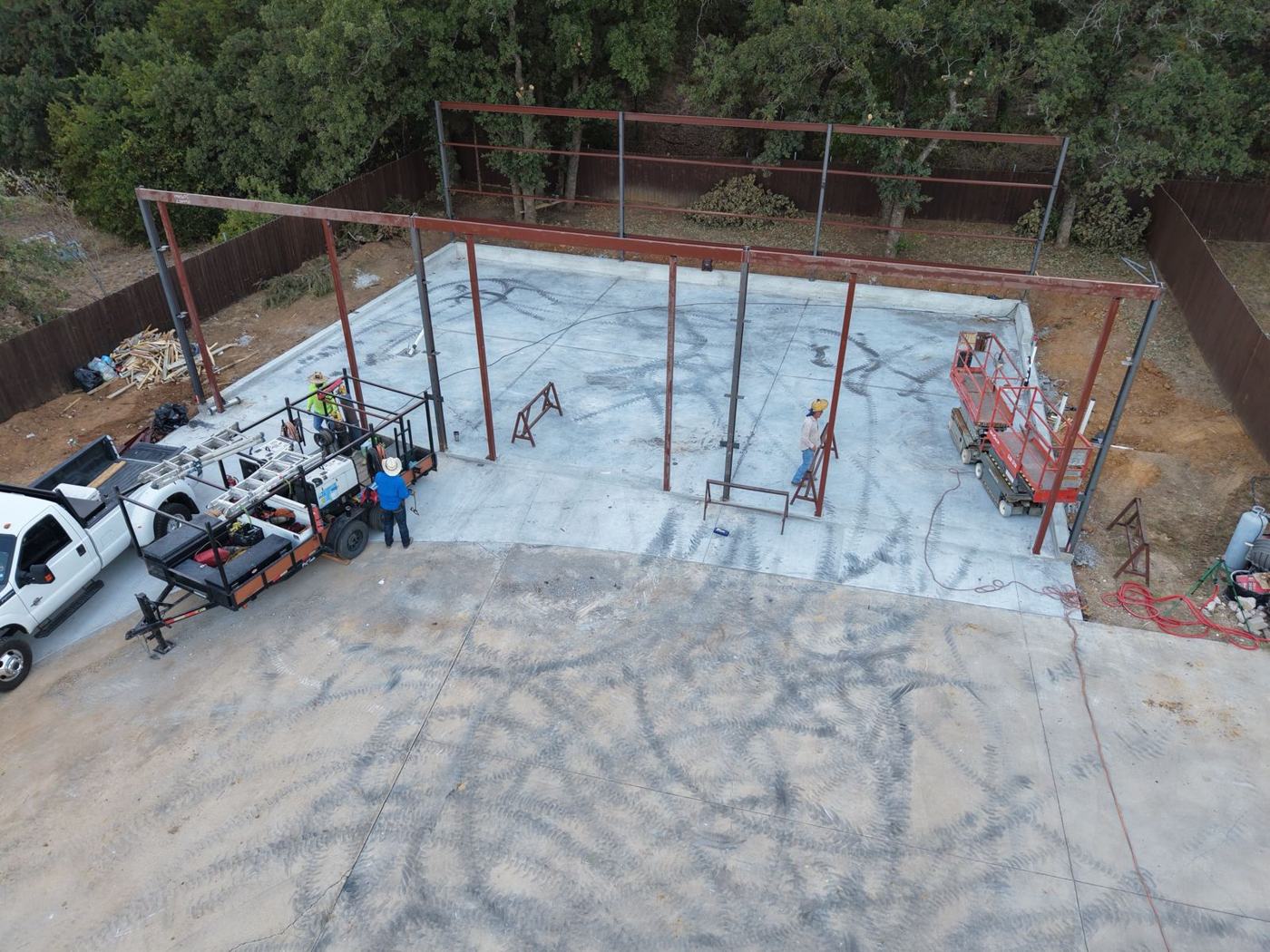 Drone view of a steel frame going up on a new slab